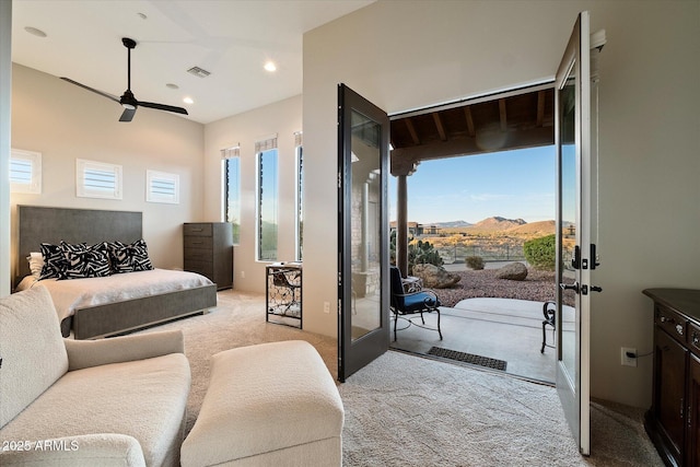 bedroom featuring light colored carpet, recessed lighting, a mountain view, access to exterior, and visible vents