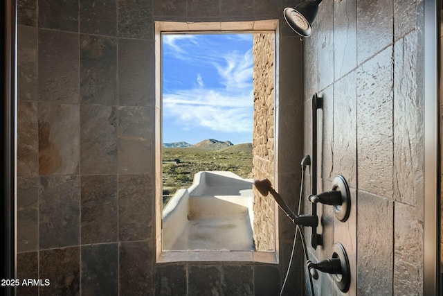 bathroom with a mountain view and a tile shower