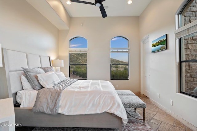 bedroom with baseboards, a ceiling fan, recessed lighting, and stone tile flooring