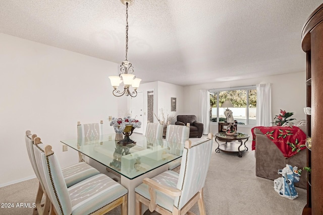 dining space with a textured ceiling, light colored carpet, and an inviting chandelier