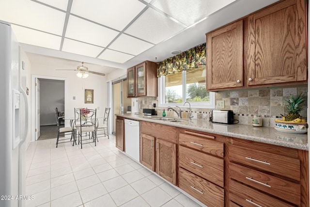 kitchen featuring decorative backsplash, ceiling fan, white appliances, and sink