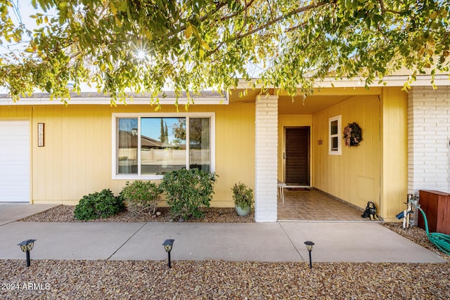 view of exterior entry featuring a garage