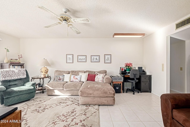 tiled living room with a textured ceiling and ceiling fan