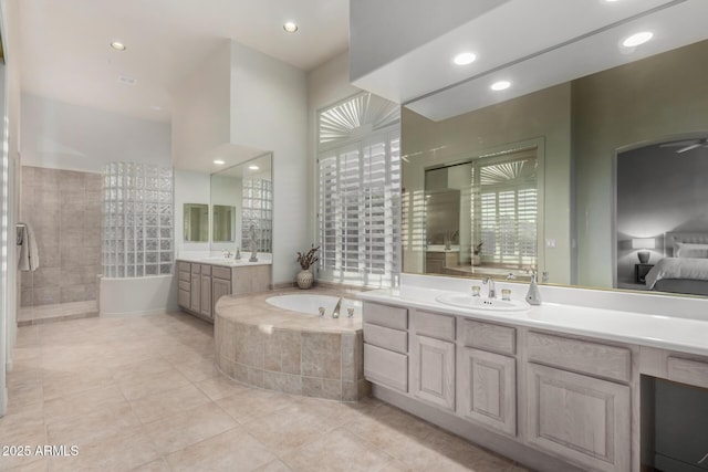 bathroom featuring a sink, a bath, recessed lighting, and tile patterned flooring