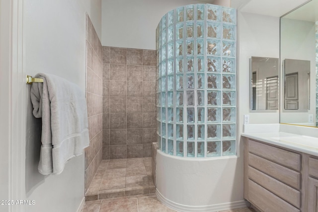 bathroom featuring walk in shower and vanity