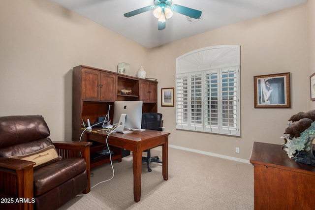 home office with visible vents, baseboards, a ceiling fan, and light colored carpet