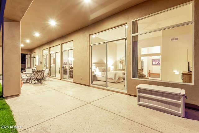 view of patio / terrace with visible vents and heating unit