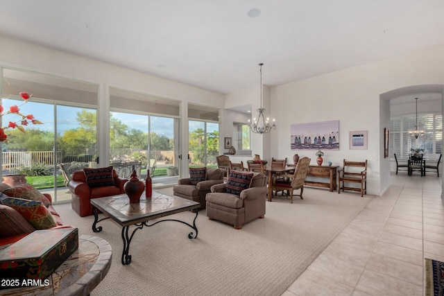 tiled living room with a chandelier and arched walkways