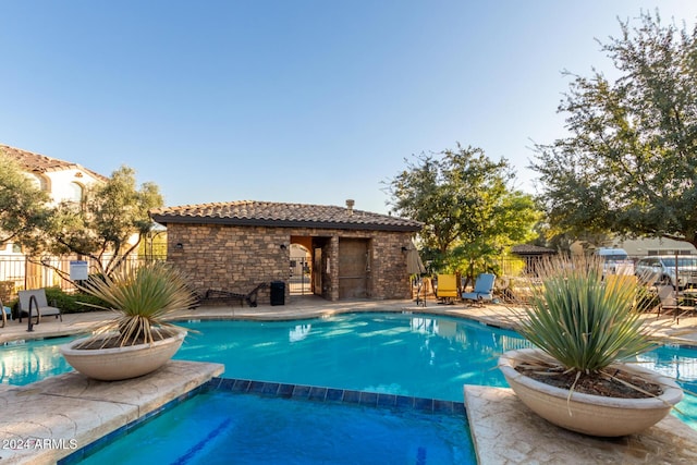 view of swimming pool with an in ground hot tub and a patio