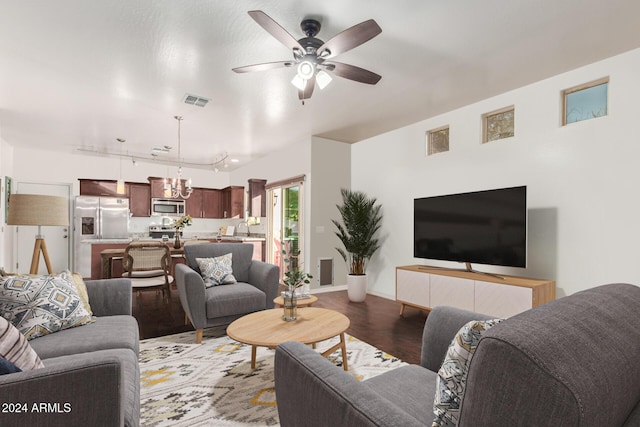 living room with ceiling fan, dark hardwood / wood-style flooring, rail lighting, and sink