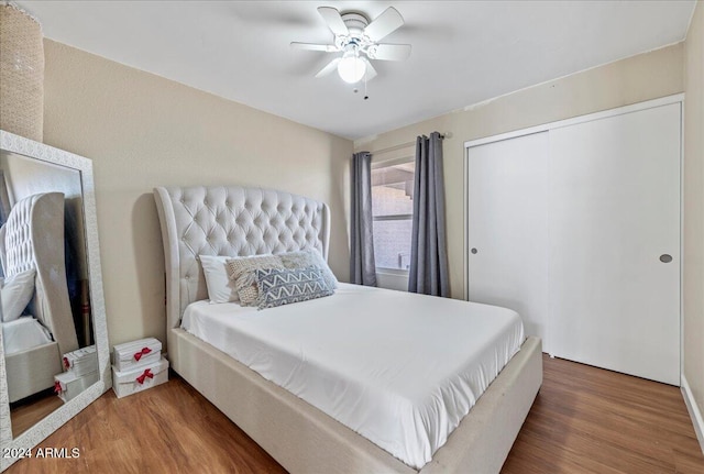 bedroom featuring hardwood / wood-style floors, a closet, and ceiling fan