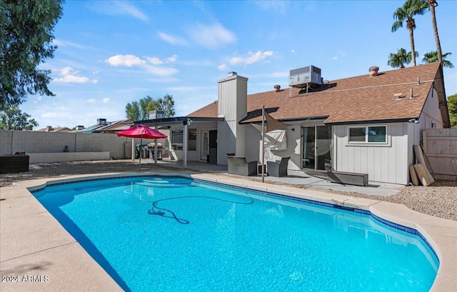 view of pool with a patio and cooling unit