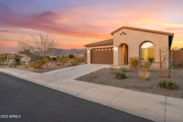 mediterranean / spanish-style house featuring a mountain view and a garage