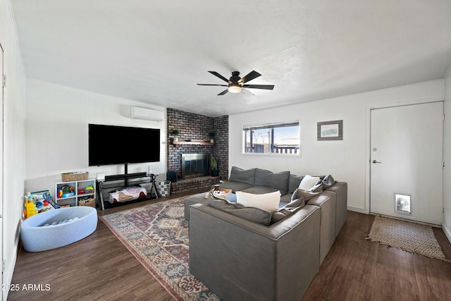 living room with ceiling fan, a fireplace, wood finished floors, and a wall mounted air conditioner