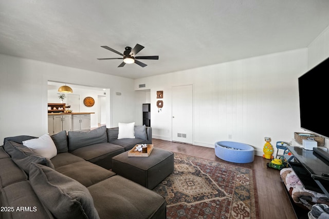 living room featuring a ceiling fan, visible vents, and wood finished floors