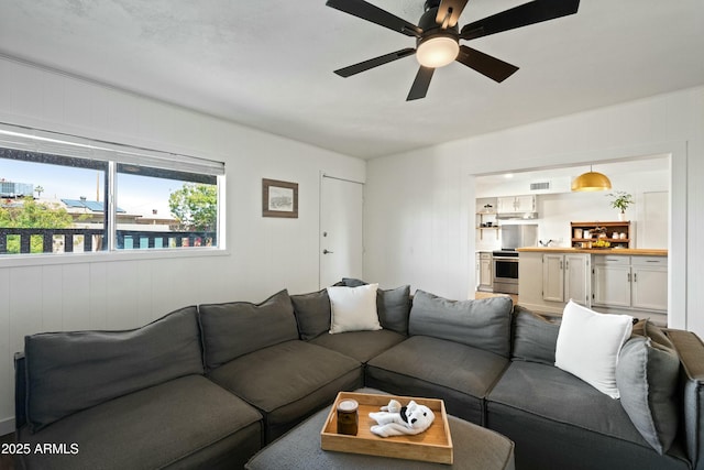 living room with visible vents and ceiling fan