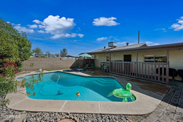 view of swimming pool featuring a patio, a fenced backyard, a fenced in pool, and central air condition unit