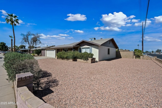 view of property exterior featuring driveway and an attached garage