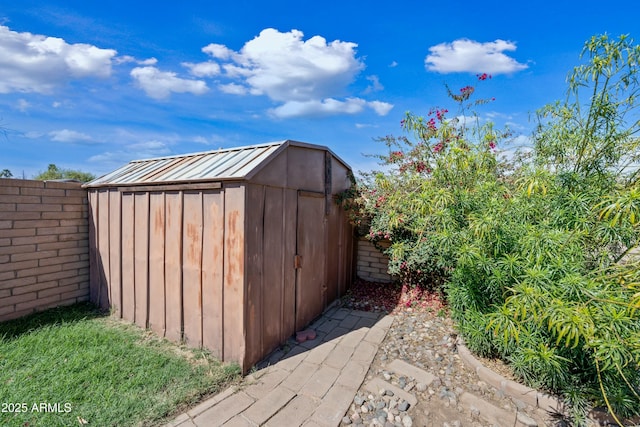 view of shed with fence