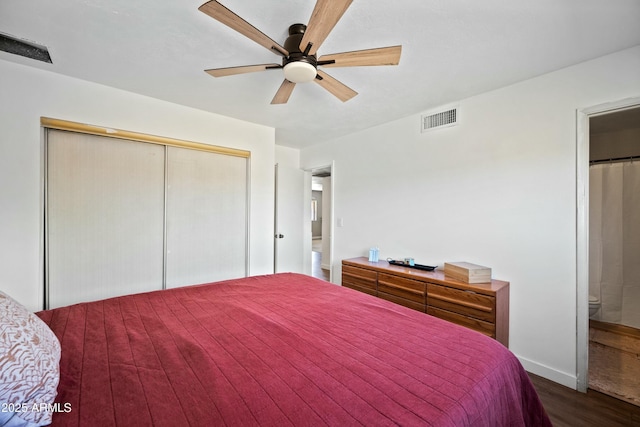 bedroom featuring baseboards, visible vents, a closet, and wood finished floors