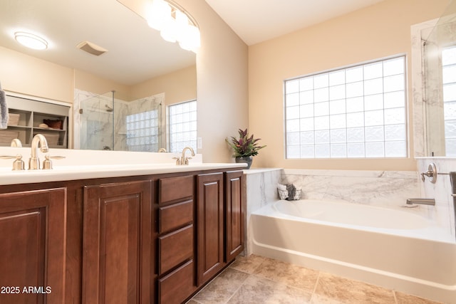 full bathroom with a garden tub, a sink, visible vents, a shower stall, and double vanity