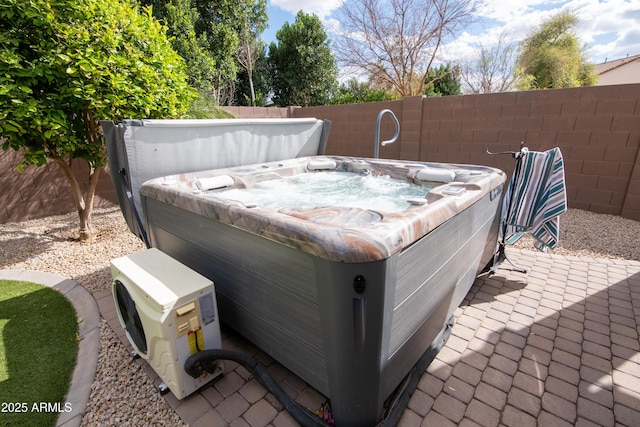 exterior space with ac unit, a hot tub, and fence