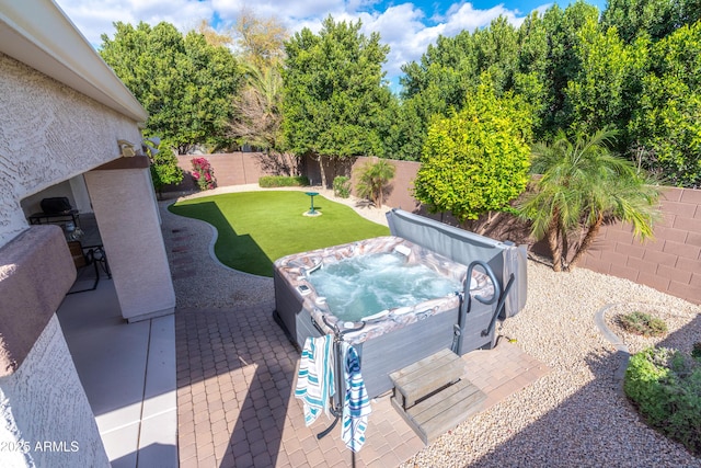 view of patio featuring a fenced backyard and a hot tub