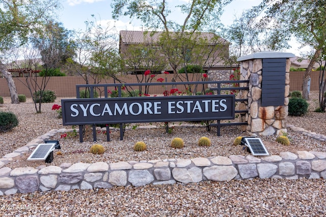 community / neighborhood sign with fence