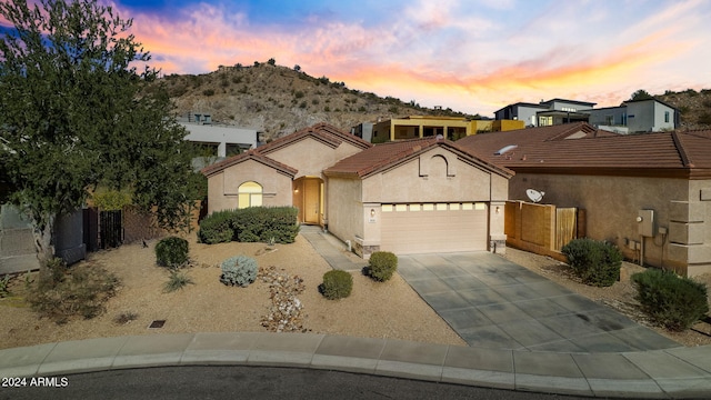 view of front of home with a mountain view and a garage