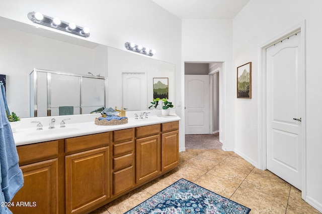 bathroom featuring tile patterned flooring, vanity, and walk in shower