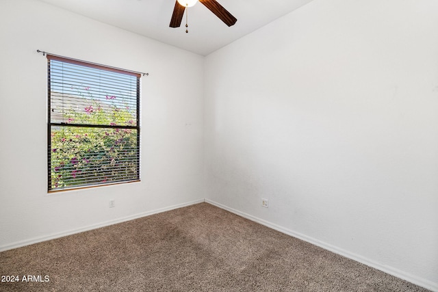 spare room featuring carpet and ceiling fan