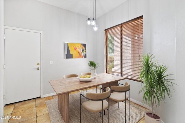 dining area featuring an inviting chandelier and light tile patterned flooring