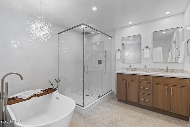 full bathroom with double vanity, a sink, a freestanding bath, and a shower stall