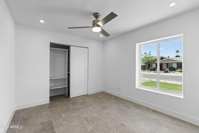 unfurnished bedroom featuring baseboards, recessed lighting, ceiling fan, and a closet