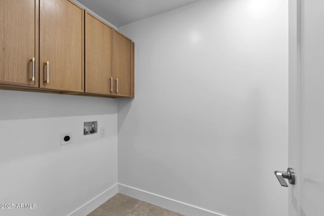 washroom featuring electric dryer hookup, cabinet space, baseboards, and washer hookup