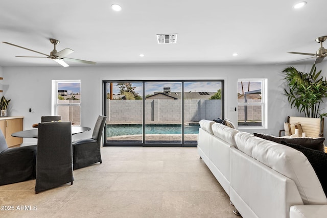 living area featuring a ceiling fan, visible vents, and recessed lighting