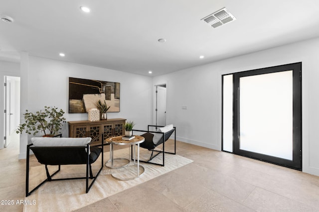 interior space featuring baseboards, recessed lighting, and visible vents