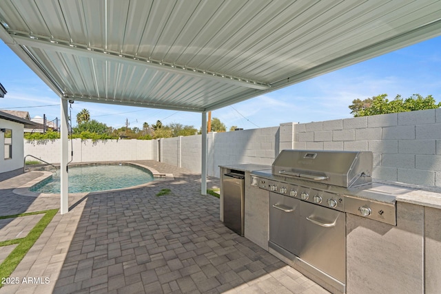 view of patio featuring a fenced backyard, a fenced in pool, and an outdoor kitchen