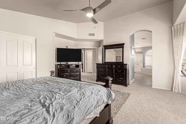 carpeted bedroom with connected bathroom and ceiling fan