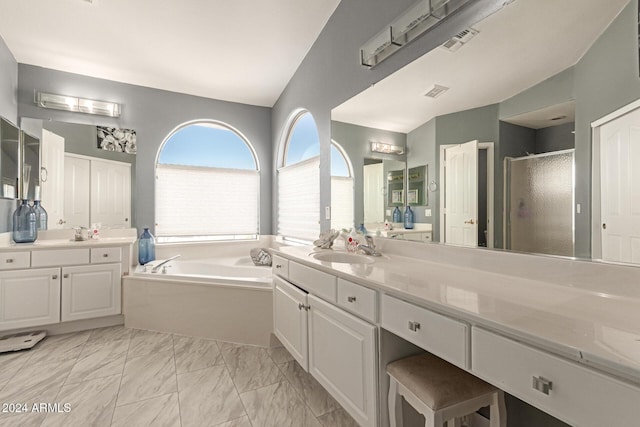 bathroom featuring vanity, separate shower and tub, and lofted ceiling