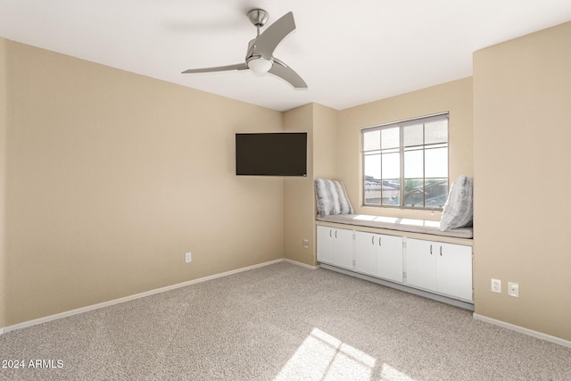 unfurnished bedroom featuring light colored carpet and ceiling fan