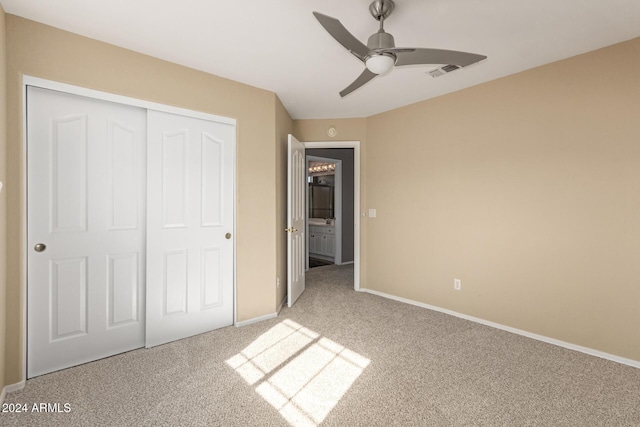 unfurnished bedroom featuring ceiling fan, a closet, and carpet