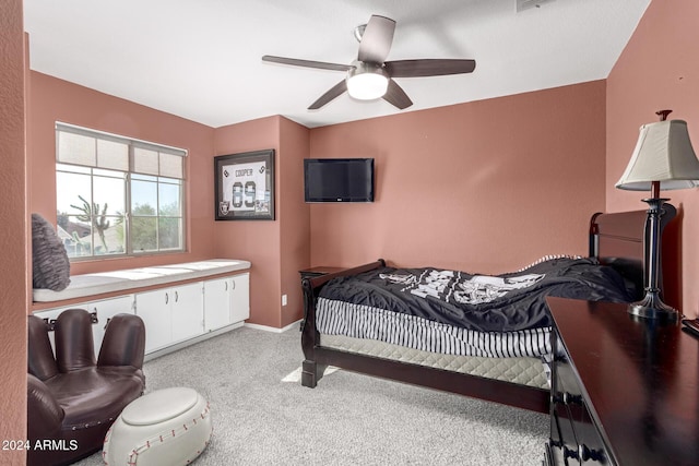 bedroom featuring light colored carpet and ceiling fan