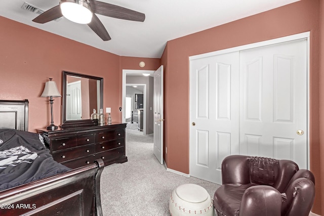 bedroom featuring light carpet, a closet, and ceiling fan