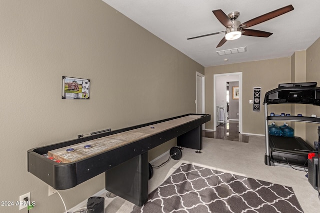 recreation room featuring light carpet and ceiling fan