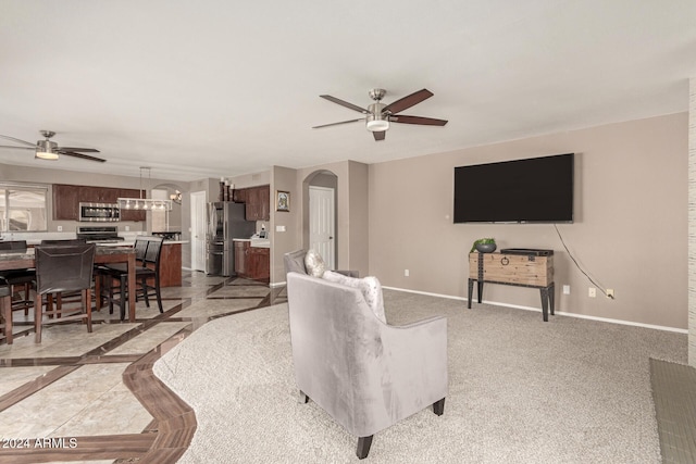 carpeted living room with ceiling fan