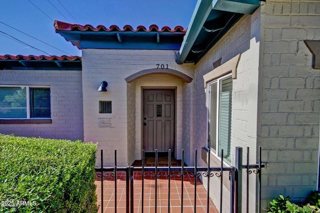 property entrance featuring concrete block siding and a gate