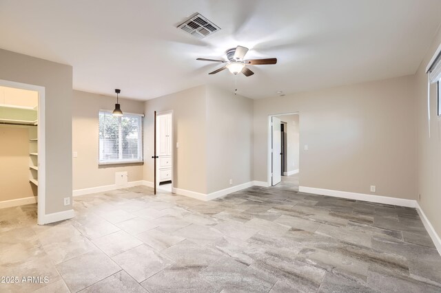 interior space with a ceiling fan, visible vents, and baseboards