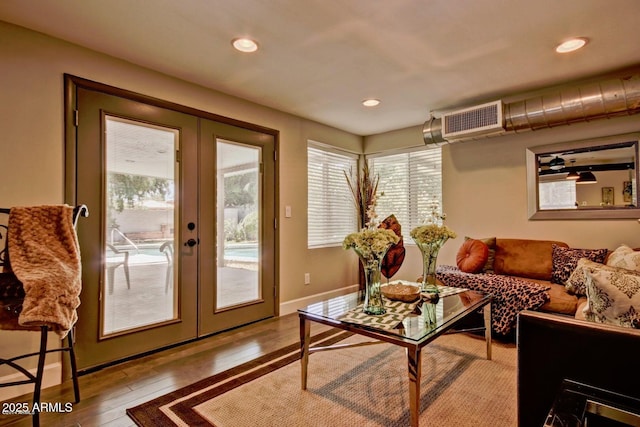 living area featuring light wood finished floors, recessed lighting, visible vents, and french doors