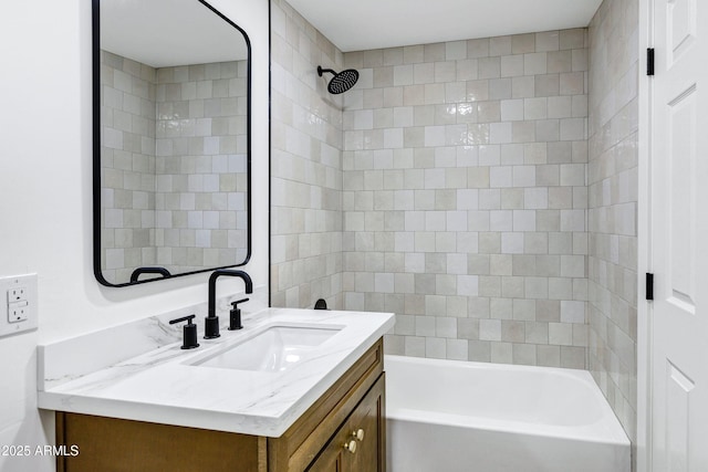 bathroom featuring vanity and tiled shower / bath combo